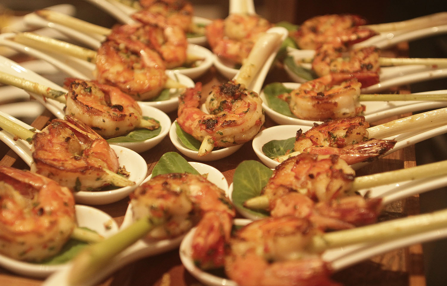 Shrimp skewers presented on soup spoons