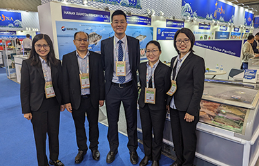 Staff from Hainan Xiangtai in front of their booth at Seafood Expo Global