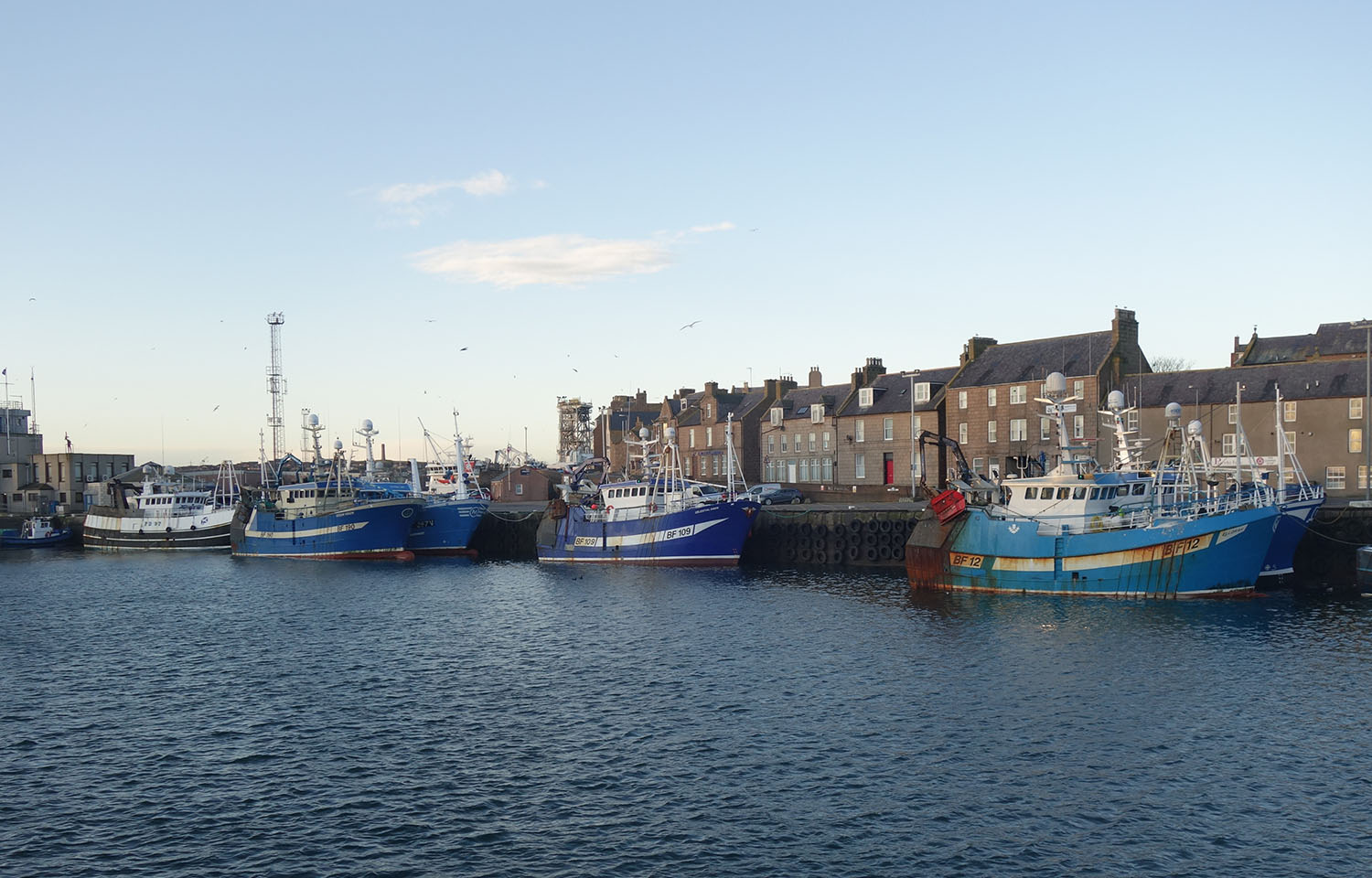 Fishing boats along the quay in the harbor of Peterhead, Scotland