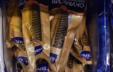 A selection of packaged mackerel in a Russian grocery store.