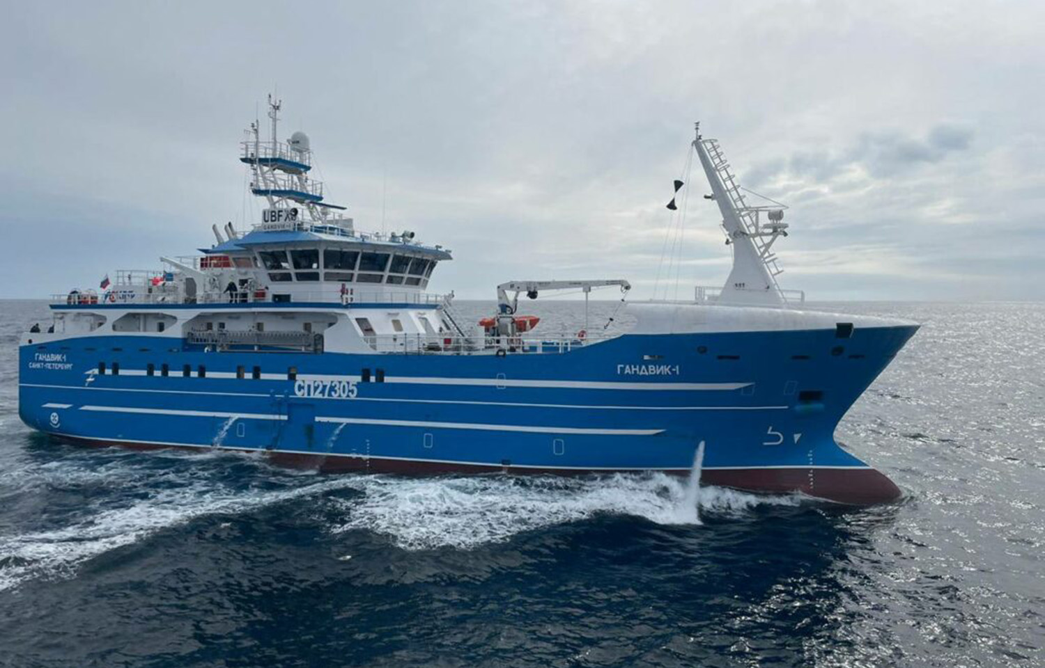 A blue-colored Russian fishing vessel at sea.