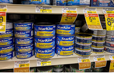 A shelf featuring Starkist canned tuna.