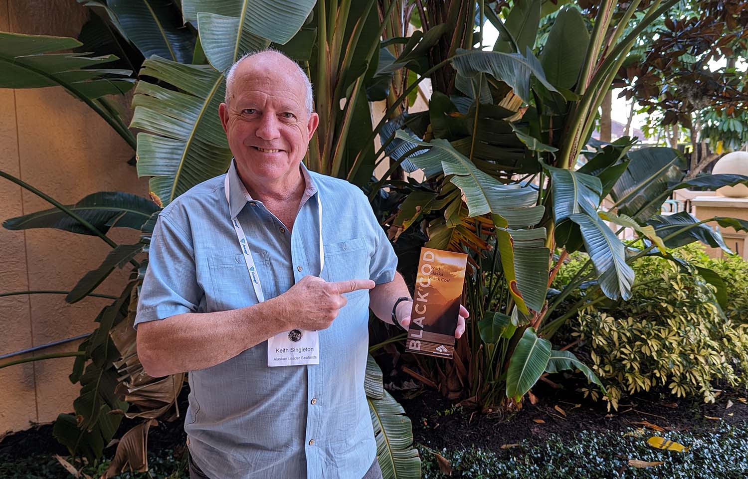 Keith Singleton showing off a pamphlet detailing Alaskan Leader Seafoods' miso black cod.