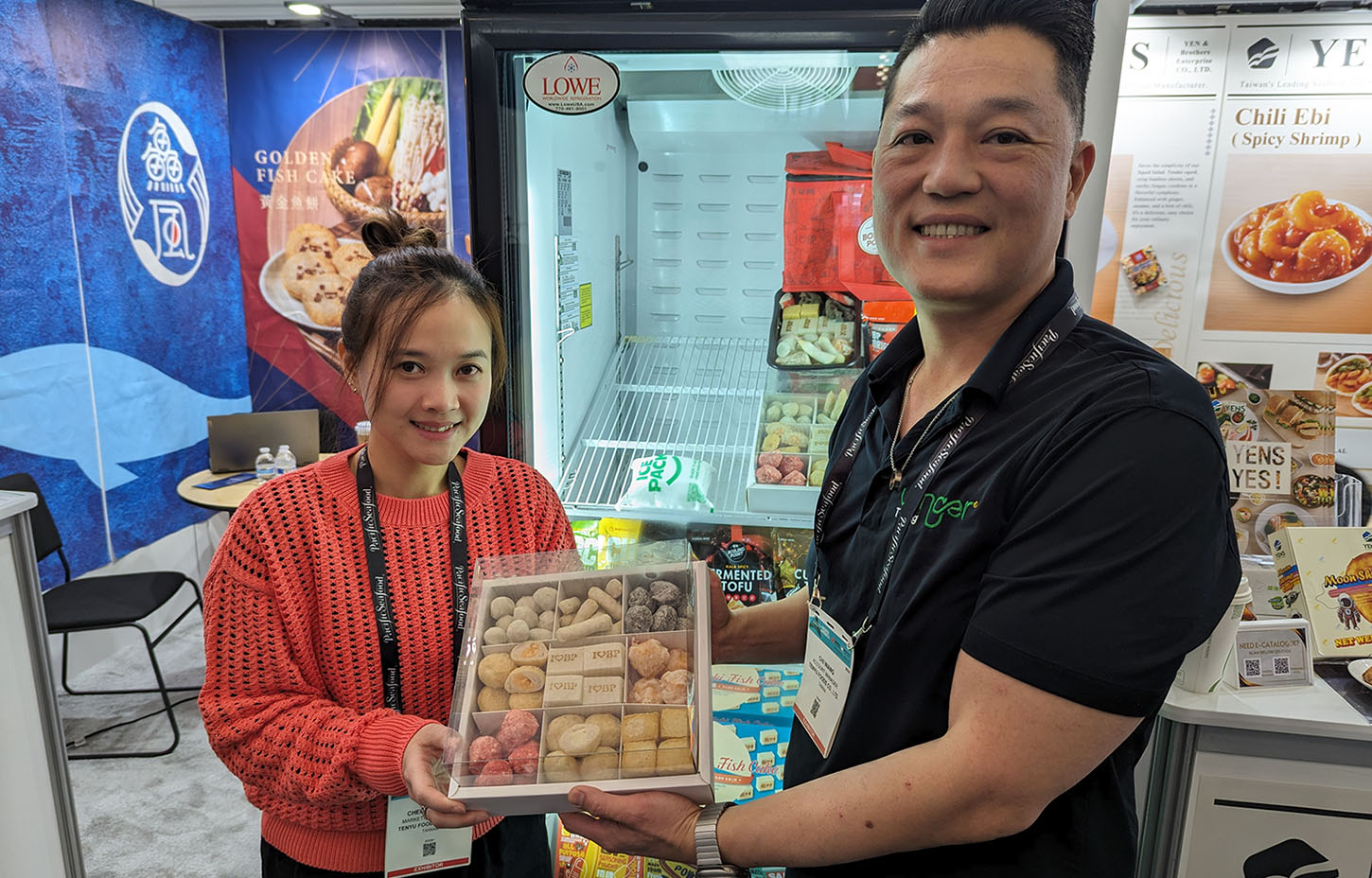 Tenyu Foods Co. employees showing off the company's fish cake products at their booth at Seafood Expo North America