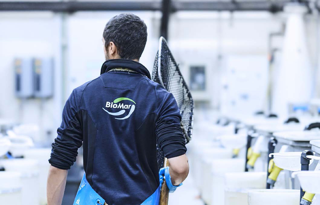 A BioMar employee holding a net inside one of the company's facilities