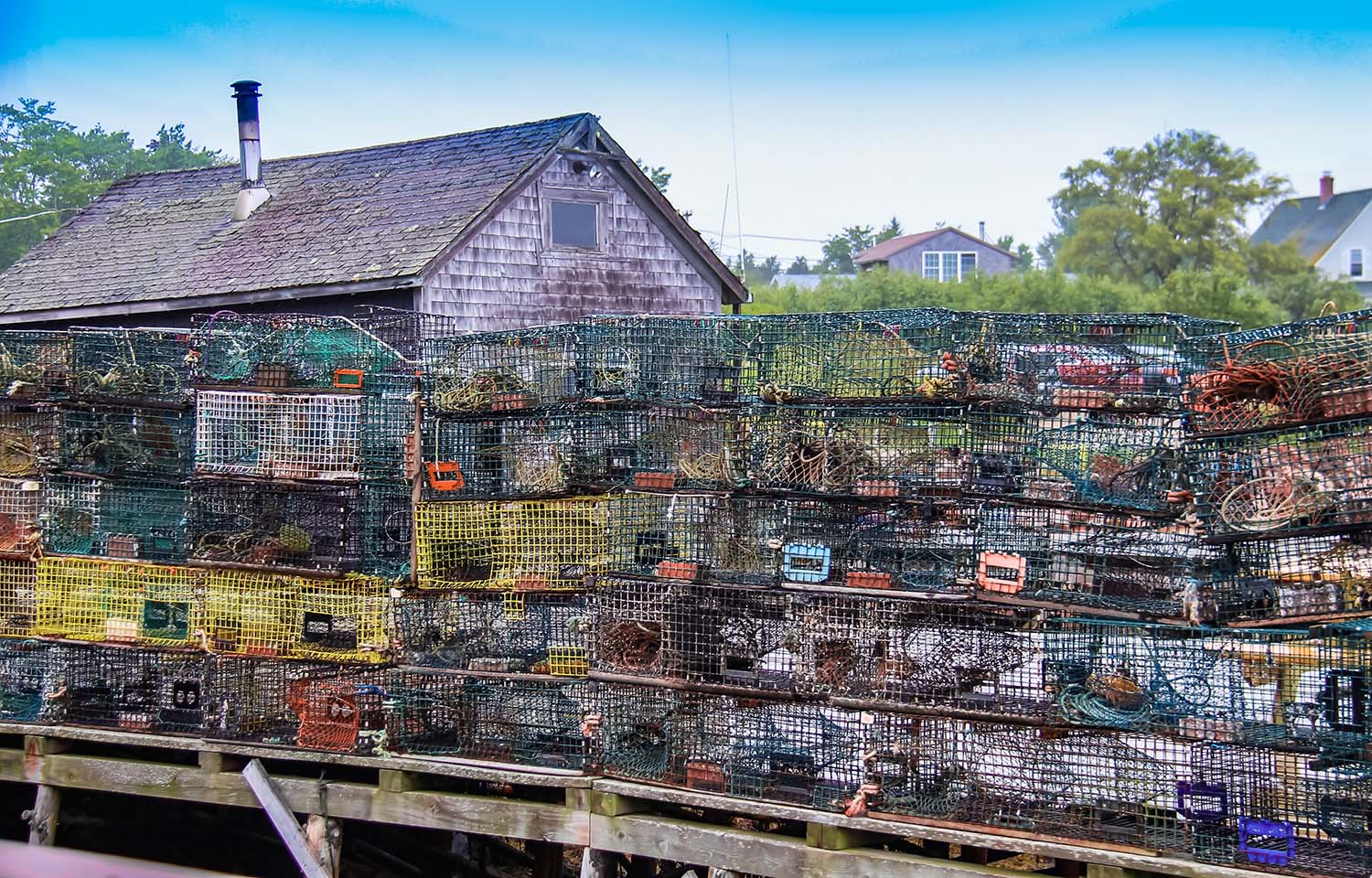 A pile of lobster traps on a dock in Maine