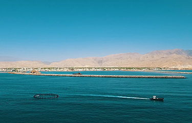 A sea cage being hauled into place in Oman.
