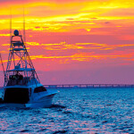 A boat sailing at sunset.