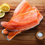 Fillets of Coho salmon on a wooden countertop