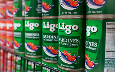 A shelf of Ligo canned sardines.