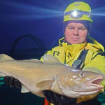 A Norcod employee holds up a farm-raised cod.