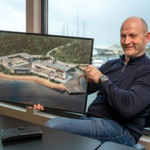 American Aquafarms Founder Mikael Rønes holds an image depicting a part of the company's planned project.