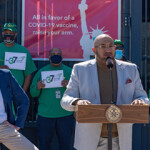 New York City Mayor Bill de Blasio and Henry Garrido, of the DC-37 union, tour a COVID-19 mass vaccination site.