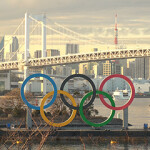 The Olympic Rings in front of the Tokyo skyline.