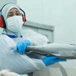 A worker holds a frozen salmon at a Salmones Austral plant.