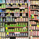 Canned tuna on grocery store shelves.