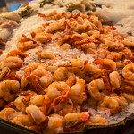 A pile of cooked shrimp on ice