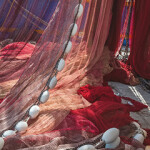 Trawl fishing nets drying on a pier.