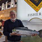 Triad Fisheries Co-Owner Mark Tupper posing with one of the company's salmon.