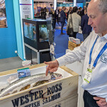 James "Gilpin" Bradley showcasing one of the company's salmon at Seafood Expo Global in Barcelona, Spain.