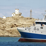 A Nueva Pescanova ship sales near an island.