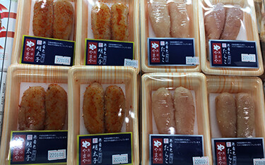 A selection of various mentaiko products by Yamaya Communications inside packaging.