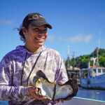 A pearl fisher on the Pacific Island of Tuvalu holds a large oyster.
