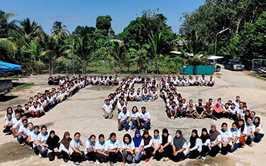 Tuna Paradise's employees pose for a photo on the company's anniversary.