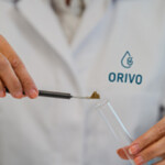 An ORIVO worker places a fishmeal sample into a test tube.