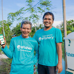 eFishery Co-Founder and CEO Gibran Huzaifah with a shrimp farmer.