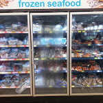 A frozen seafood section inside a grocery store.
