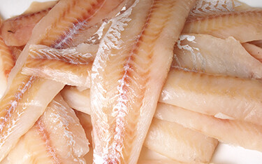Alaska pollock fillets in a pile.