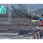 A man throwing aquaculture feed into a net pen with the ASC logo in a corner.