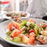 Restaurant chefs prepare a shrimp dish for diners.