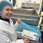 A Kingfish Company employee giving a thumbs up in the company's processing plant.