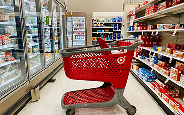 Target cart in front of refrigerated foods section