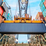 Shipping container with a crane