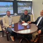 Virginia Secretary of Natural Resources Travis Voyles, Virginia Marine Resources Commission (VMRC) Commissioner Jamie Green, and Ocean Harvesters CEO Monty Deihl sign a MoU.