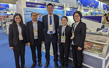 Staff from Hainan Xiangtai in front of their booth at Seafood Expo Global