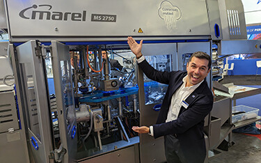 Marel Global Sales Director Diego Lages showing off the company's new MS 2750 salmon filleting machine.