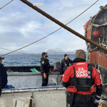 The U.S. Coast Guard and other authorities board an unidentified trawler in Alaska.