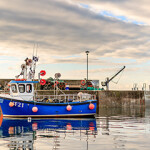 A fishing boat at a pier in Scotland.