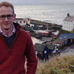 U.K. Government Minister for Scotland John Lamont standing by the oceanside.