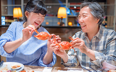 Restaurant-goers eating crab.