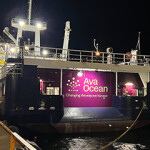 A banner promoting Ava Ocean on the back of a Norwegian fishing vessel.