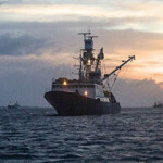 A tuna vessel at sunset in the South Pacific.