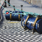 Two biomass cameras for aquaculture sitting on a dock.