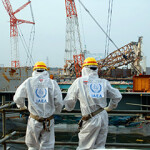 Two IAEA experts examining recovery work at the Fukushima Daiichi Nuclear Power Station.