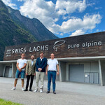 Swiss Lachs management posing in front of the company's recirculating aquaculture system facility in Switzerland.