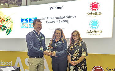 Tassal Head of Sales and Marketing Matt Vince and General Manager of Marketing Libby Williams accepting the trophy from Diversified Communications Vice President of Seafood Wynter Courmont